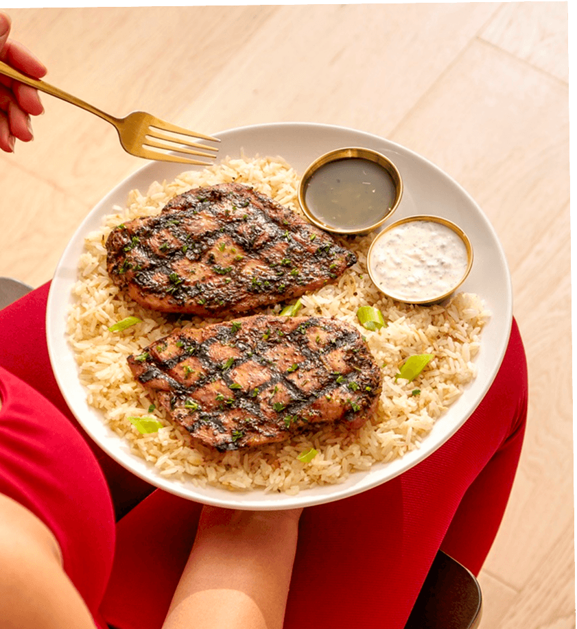 Grilled chicken meal with rice and sauces