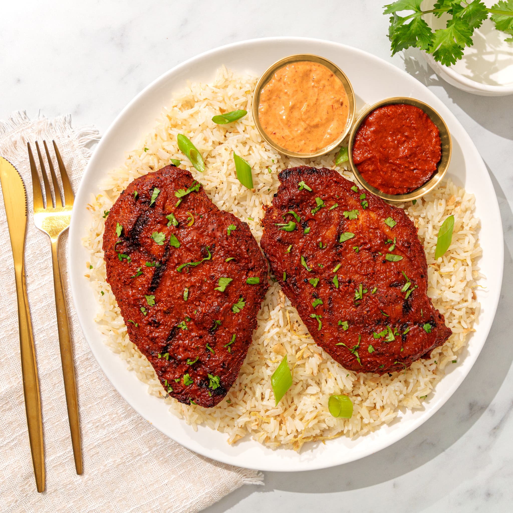 Pollo Asado grilled chicken breasts over rice